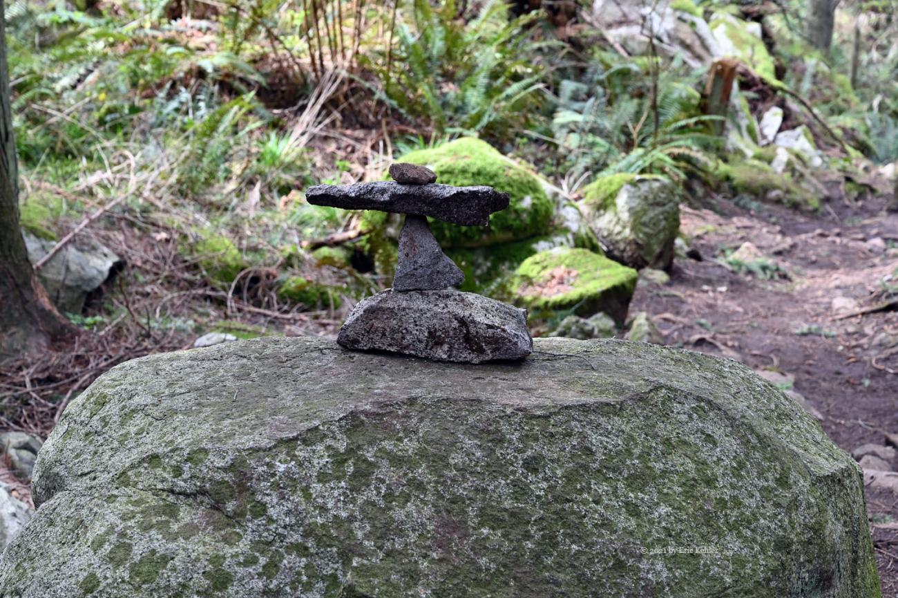A small rock art sculpture alongside the trail