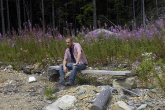 Geoff sitting enjoying the view before lunch after building the bench