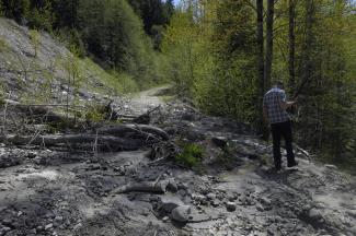 Geoff inspecting the mudslide on Anderson South to see if we could cross