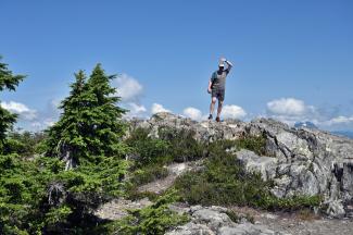John on the summit of Mount Strachan